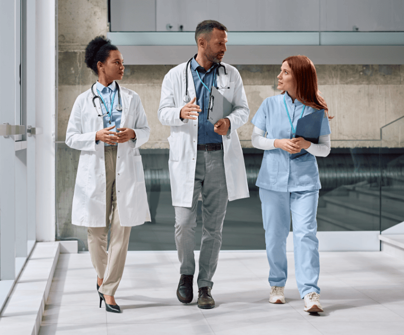 health-center-career-header A group of doctors walking down a hallway together. They are deep in conversation.